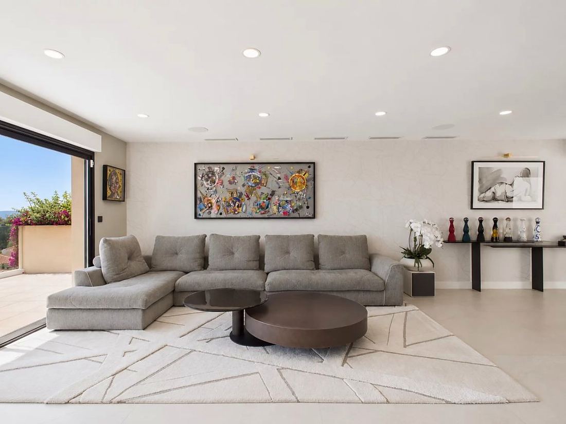 Living room seating area with artwork and terrace doors