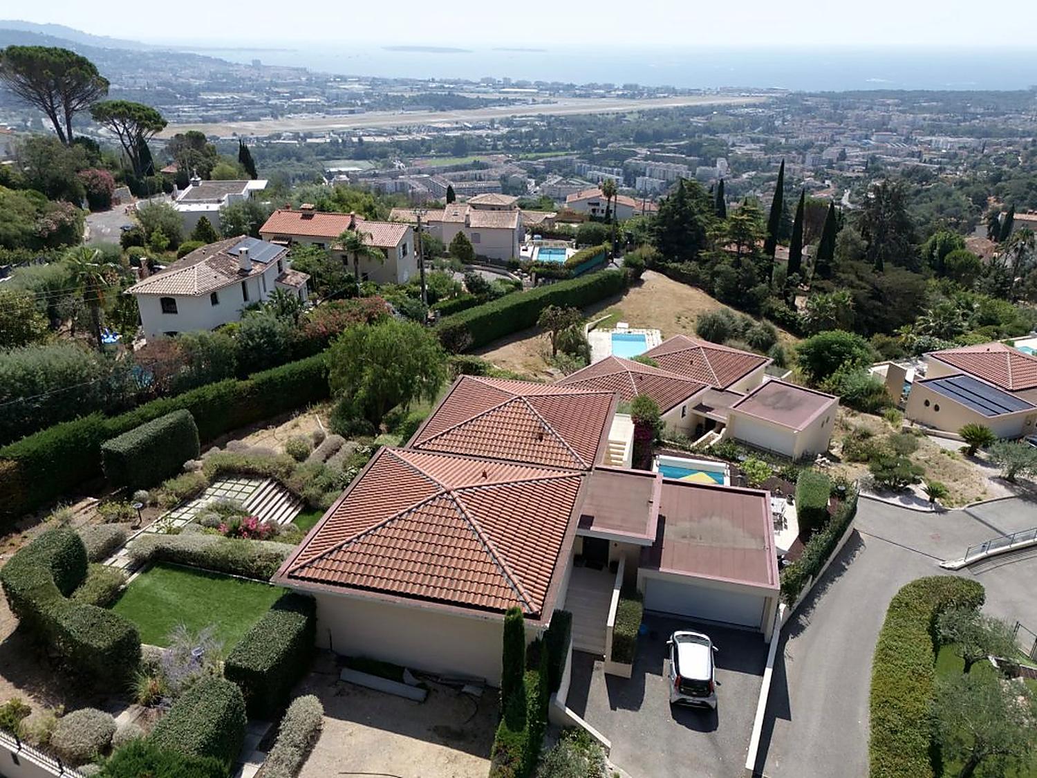 Aerial view over the hillside towards the bay and the sea